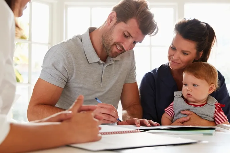 Parents and baby looking at support paperwork