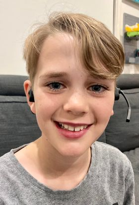 boy earing Shokz headphones